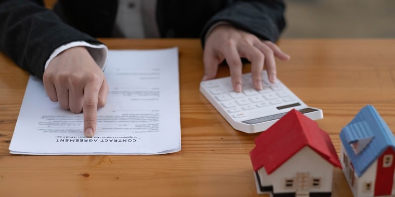 business woman presenting home insurance contract