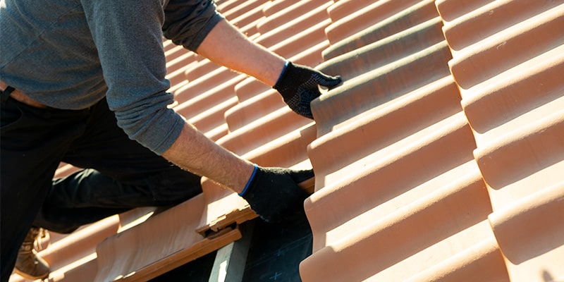 roofer laying roof tiles