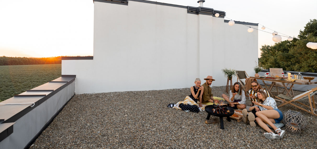 People socialising on flat roof with coping.