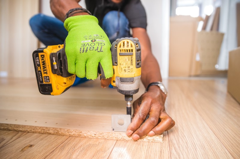 man drilling into wood