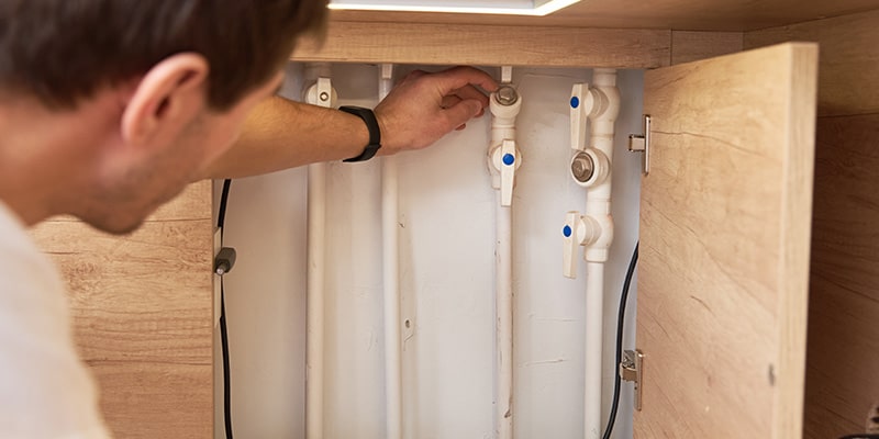 man checking water pipes