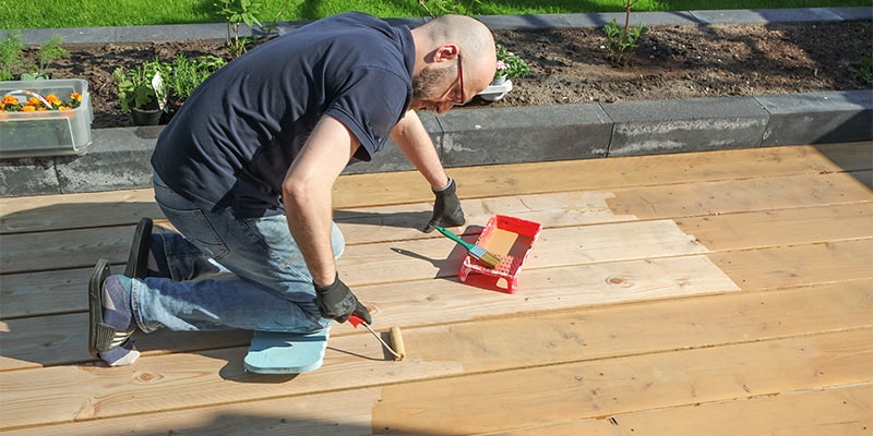 man painting decking