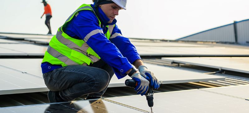 technician installing solar roof tiles