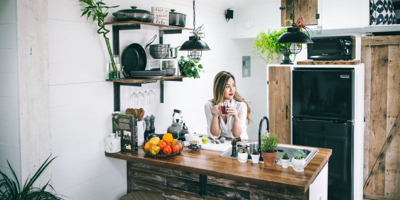 woman sat behind wooden kitchen table