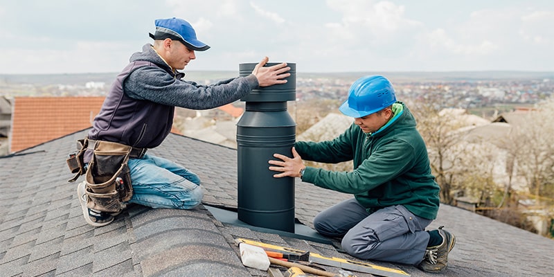 workmen working chimney roof